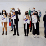 Jorge Rodriguez surrounded by the rest of the Venezuelan government delegation to the Mexico Talks, all holding an image of the Venezuelan diplomat Alex Saab who was kidnapped by the Cape Verdean government following an unsubstantiated extradition request from the United States. Photo courtesy of Twitter / @jorgepsuv.