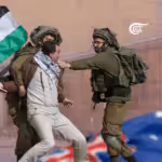 Man carrying a Palestinian flag being repressed by IDF gendarmes. Photo courtesy of Al Mayadeen English.