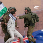 Man carrying a Palestinian flag being repressed by IDF gendarmes. Photo courtesy of Al Mayadeen English.