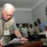 President Carter checking his notes while observing a polling station in Maputo, Mozambique, in December 2004. Since 1989 the Carter Center has been observing elections worldwide. Photo courtesy of CNN.