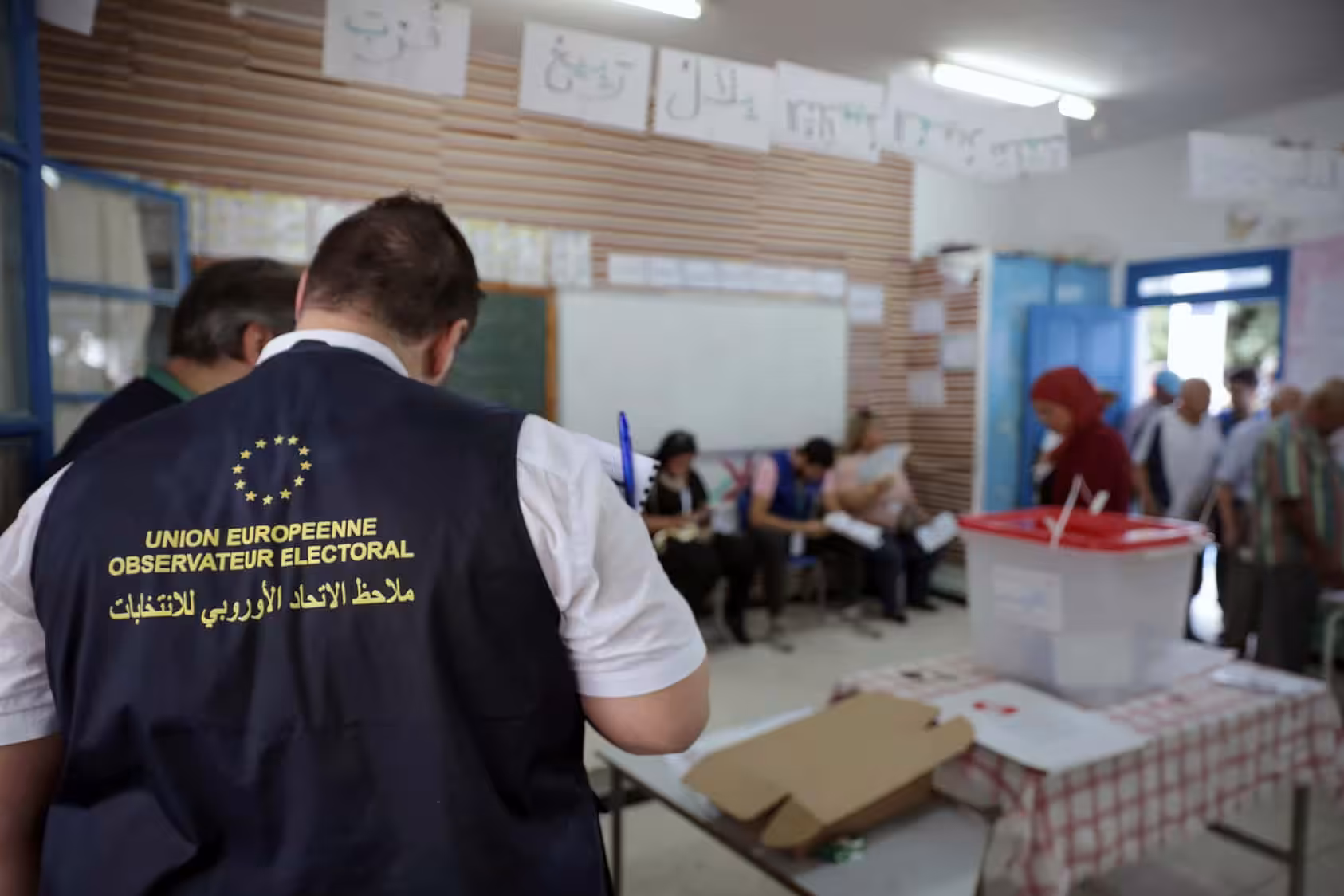 Observers from the European Union monitor the election process inside a polling station outside Tunis during the first round of the presidential election on September 15, 2019. (Mosa’ab Elshamy/AP).