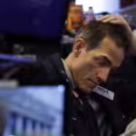 New York stock exchange trader after a bad day putting his hand in his head. File photo.