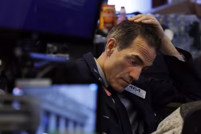 New York stock exchange trader after a bad day putting his hand in his head. File photo.