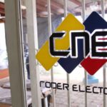 Door with a CNE logo and people working in the background. File photo.