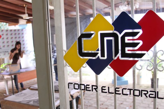 Door with a CNE logo and people working in the background. File photo.