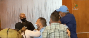 Featured image: Moment captured by Telesur when opposition candidate for Bolivar state Raul Yusef slapped opposition candidate Americo de Grazia in the face. Screenshot from Telesur footage.