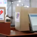 Venezuelan voting machine next to a ballot box. File photo.