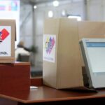 Venezuelan voting machine next to a ballot box. File photo.