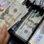 Cash register in Venezuela containing US dollars and Venezuelan bolivars. File photo courtesy of Banca y Negocios.