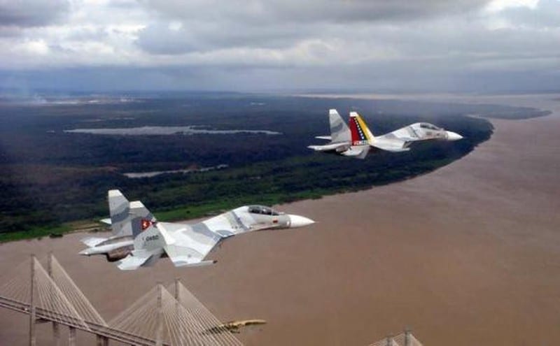 Two Venezuelan Su-32 fighter jets flying over the Orinoco river near Ciudad Guayana. Referential photo.