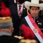 Peruvian President Pedro Castillo facing a military officer during a ceremony. Photo by CNN.