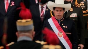 Peruvian President Pedro Castillo facing a military officer during a ceremony. Photo by CNN.