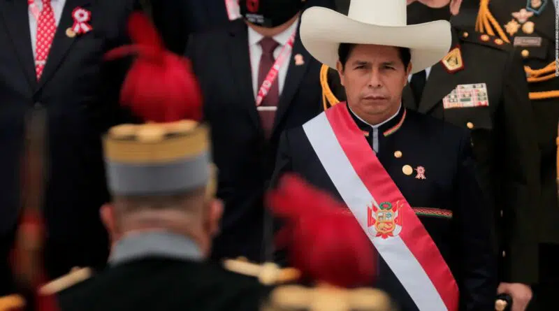 Peruvian President Pedro Castillo facing a military officer during a ceremony. Photo by CNN.