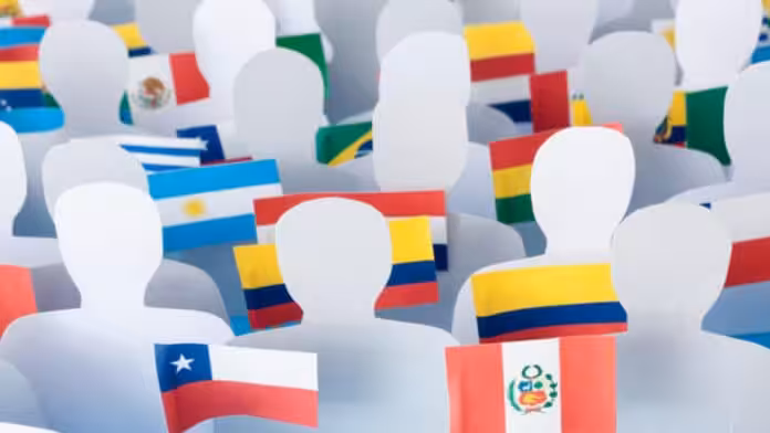 Photo composition of blank figurines holding flags of Latin American countries. Photo by RedRadioVE.