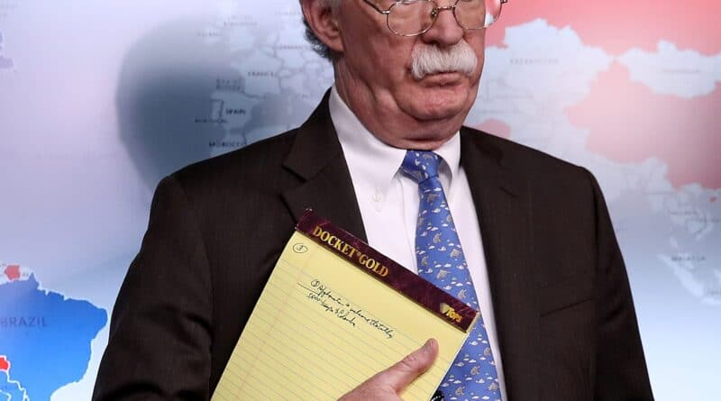 John Bolton holding a notepad with a handwriting mentioning the need to move 5000 troops to Colombia. One of Bolton's "biggest achievements" as Trump's national security advisor. Photo by Win McNamee, Getty Images.