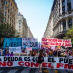 Protesters hold a banner that says 'The debt is with the people, not with the IMF' as they rally in Buenos Aires, Argentina on December 11, 2021. Photo: Natalie Alcoba/Al Jazeera