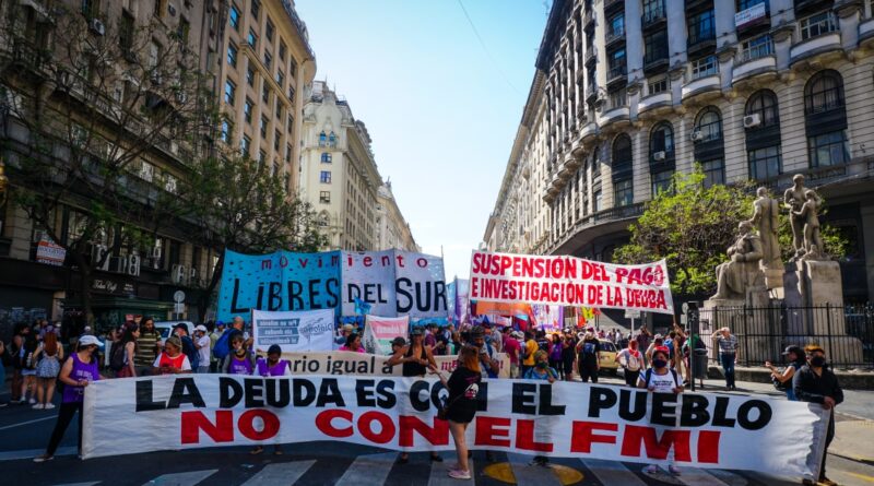 Protesters hold a banner that says 'The debt is with the people, not with the IMF' as they rally in Buenos Aires, Argentina on December 11, 2021. Photo: Natalie Alcoba/Al Jazeera