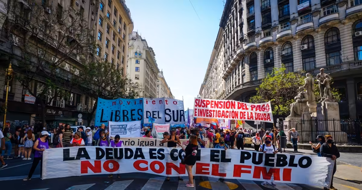 Protesters hold a banner that says 'The debt is with the people, not with the IMF' as they rally in Buenos Aires, Argentina on December 11, 2021. Photo: Natalie Alcoba/Al Jazeera