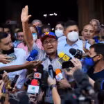 Opposition governor-elect of Barinas state, Sergio Garrido, is surrounded by the press as he leaves a Mass the day after elections in Barinas, Venezuela, January 10, 2022. Photo: Matias Delacroix / AP