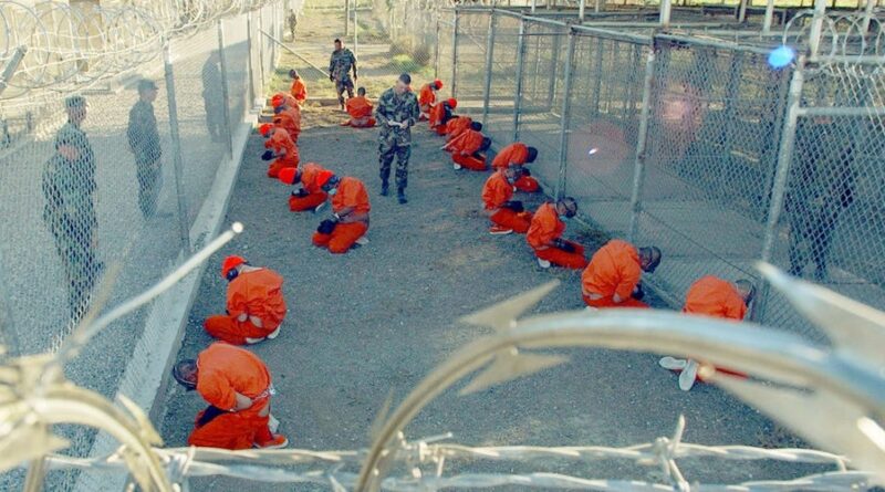 Detainees in the Guantánamo Bay Prison sit in a holding area at Camp X-Ray on January 11, 2002. Photo: Reuters/Shane T. McCoy