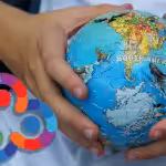 Kid holding a small ball with the South American map and the Antartida. Composition with Orinoco Tribune logo.