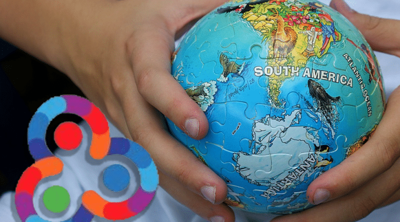 Kid holding a small ball with the South American map and the Antartida. Composition with Orinoco Tribune logo.
