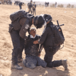 Palestinians protesting against land confiscation in the Negev desert region, being repressed by Israeli occupation forces. Photo: ActiveStills.org
