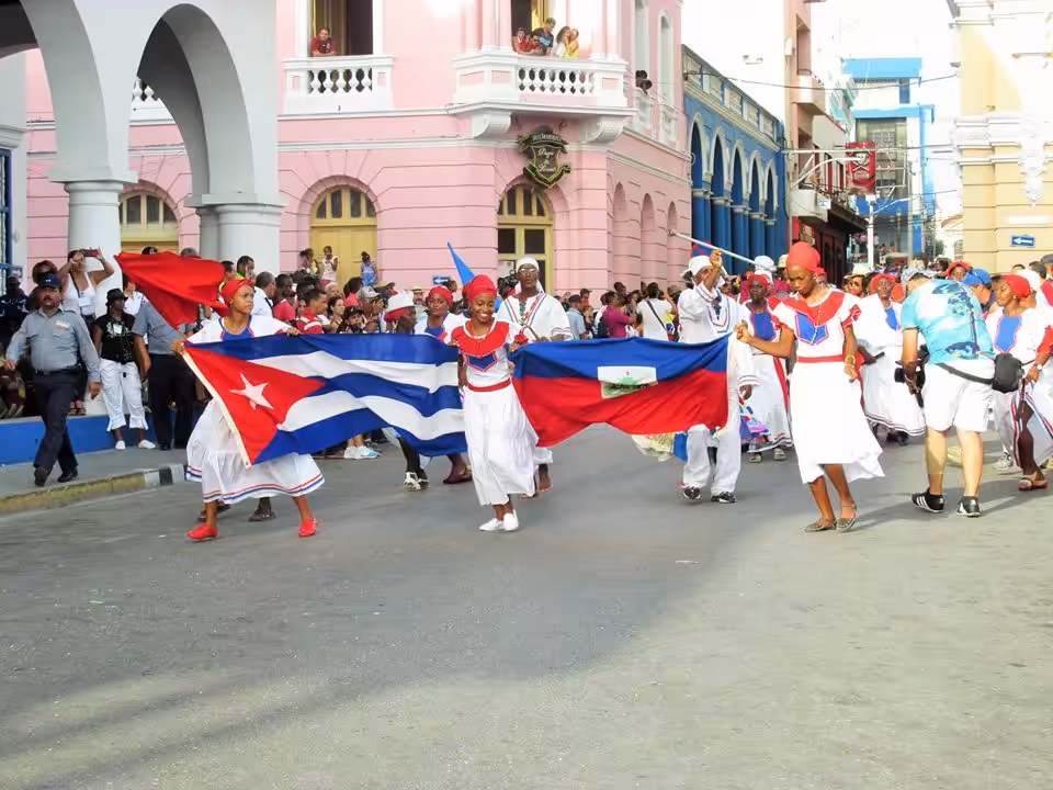 Fiesta del Fuego dancers in Santiago de Cuba holding the Cuban and the Haitian flags. File photo by SabordelCaribe blog.