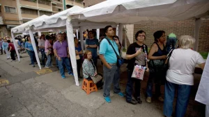 Anti-Chavista Venezuelans line up outside the Venezuelan National Electoral Council  (CNE) in Caracas, the capital, in 2016. They were confirming their signatures supporting a recall referendum against President Nicolas Maduro. Fernando Llano/AP.