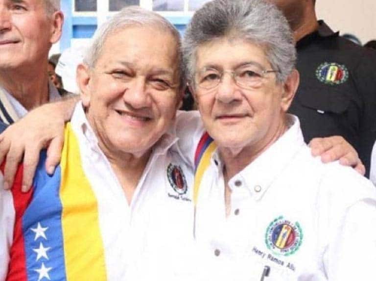 Bernabe Gutiérrez (left) and Henry Ramos Allup (right) embracing each other. File photo.