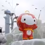 A Beijing resident takes a photo of the Beijing Winter Olympic Games mascot “Xue Rong Rong” sculpture on January 20, 2022, the solar term of Greater Cold, when the Chinese capital city experienced its first snowfall this year. Photo: cnsphoto