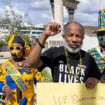 Featured image: Activist David Denny, of the Caribbean Movement for Peace and Integration, photographed during a November 2021 demo in Barbados. Credit: Mirror.