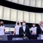 European Parliament members with white t-shirts stamped with the names of Colombians keel during the National Strike in 2021 protesting the speech of Colombian President Ivan Duque in the European Parliament. Photo: Twitter / @OezlemADemirel.