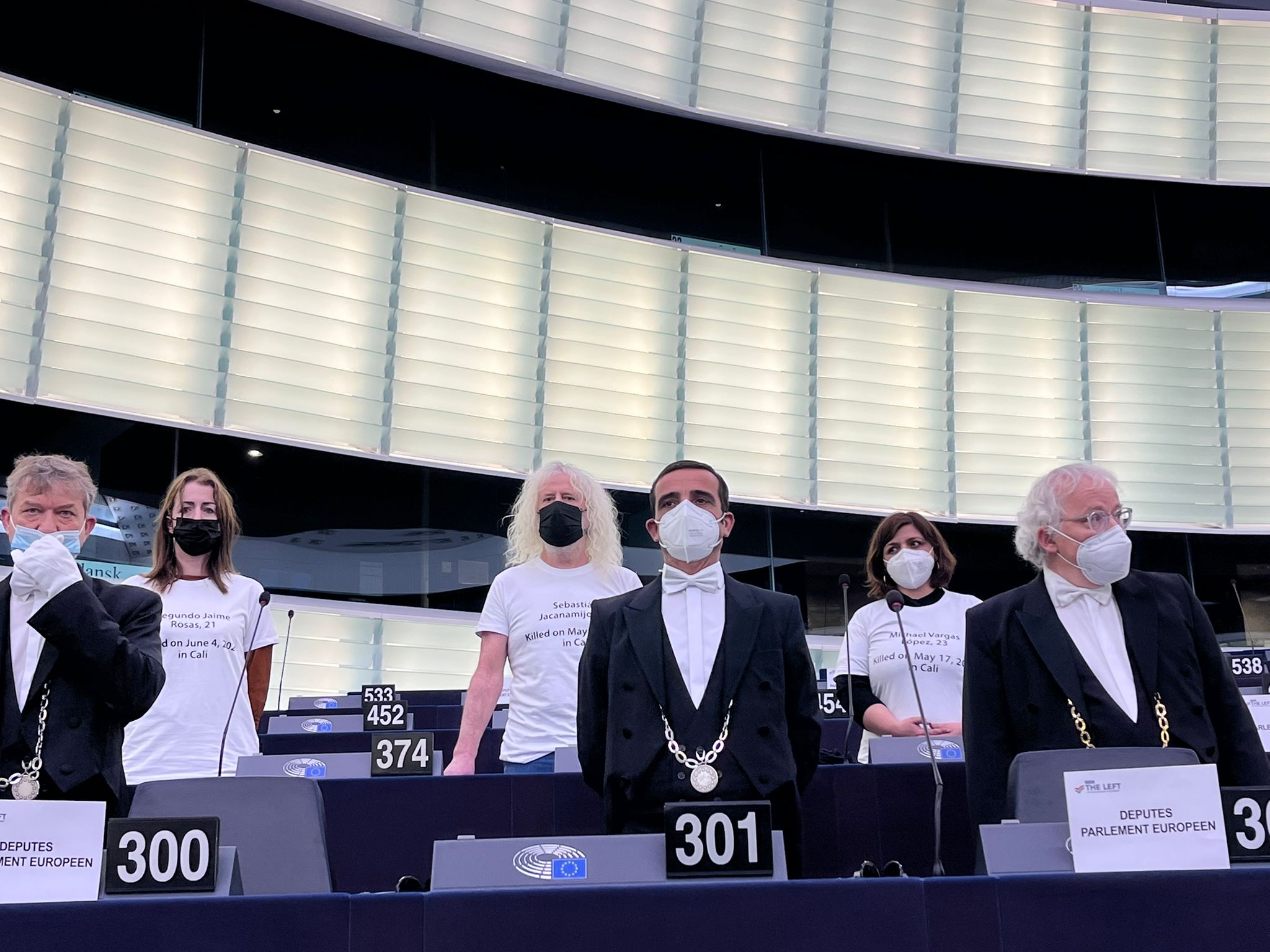 European Parliament members with white t-shirts stamped with the names of Colombians keel during the National Strike in 2021 protesting the speech of Colombian President Ivan Duque in the European Parliament. Photo: Twitter / @OezlemADemirel.