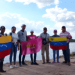 Featured image: A group of Venezuelans hoist two of their nation's flags. Photo: CRBZ