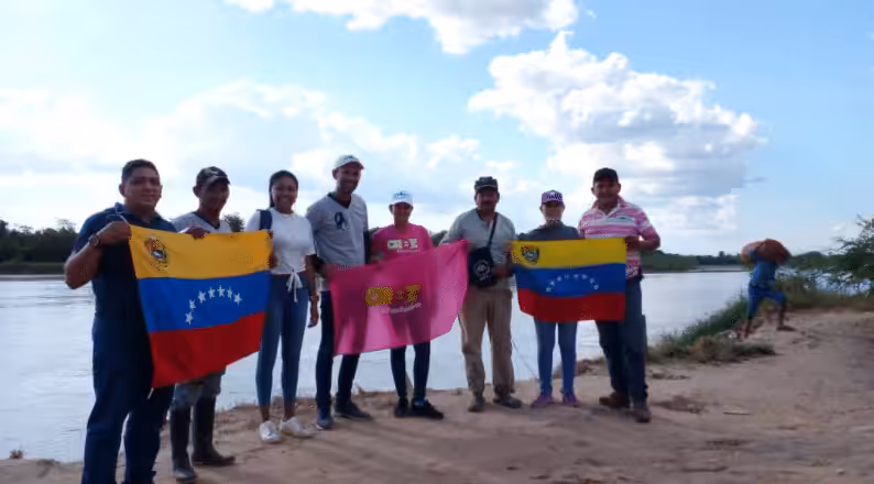 Featured image: A group of Venezuelans hoist two of their nation's flags. Photo: CRBZ