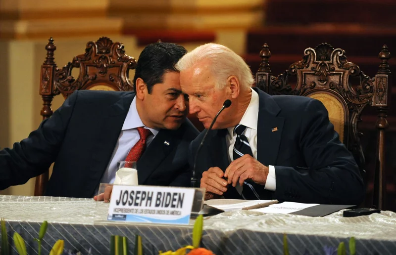 Featured image: Honduran President Juan Orlando Hernández (left) speaks with then-Vice President Biden during a news conference in Guatemala City on March 2, 2015. Photo: Johan Ordóñez / AFP via Getty Images.