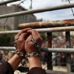 Featured Image: Palestinian prisoners' hands in chains.