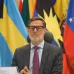 Venezuelan Foreign Affairs Minister Felix Plasencia with Latin American and Caribbean flags in the background. File photo.