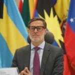 Venezuelan Foreign Affairs Minister Felix Plasencia with Latin American and Caribbean flags in the background. File photo.