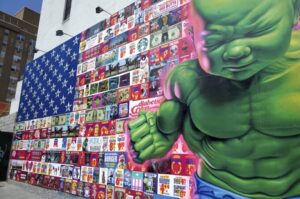 Graffiti depicting the US flag filled with logos of arms, real estate and other multinational corporations, and the figure of the hulk. Photo: Travis Wise