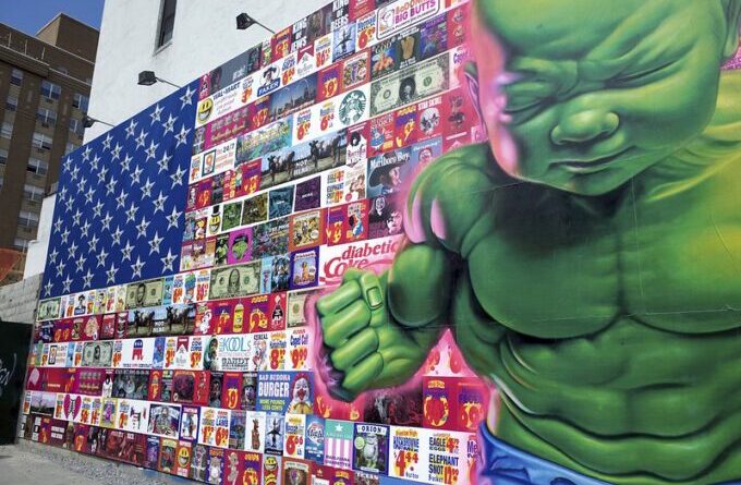 Graffiti depicting the US flag filled with logos of arms, real estate and other multinational corporations, and the figure of the hulk. Photo: Travis Wise