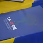 Booklet with the caption on the front page: UICOM, the International University for Communications. File photo.