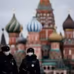 Two police officers walking down the Red Square in Moscow with the Saint Basil Cathedral in the background. Photo: Getty Images.