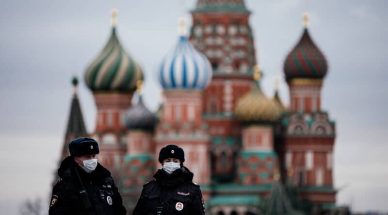 Two police officers walking down the Red Square in Moscow with the Saint Basil Cathedral in the background. Photo: Getty Images.