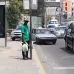 A black person waiting at a bus stop in Dominican Republic. Photo: HispanTV.