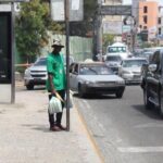 A black person waiting at a bus stop in Dominican Republic. Photo: HispanTV.