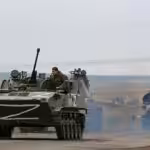 Russian military vehicles move on a highway in an area controlled by Russian-backed separatist forces near Mariupol, Ukraine, Monday, April 18, 2022. Mariupol. © AP Photo/Alexei Alexandrov.