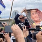 Jorge Glas in a meeting after his release holding a poster with the image of former president Rafael Correa. Photo: Twitter / @LitoTorres97.