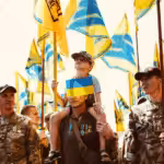 Azov Regiment veterans, whose banners carry an emblem derived from a Nazi symbol, the Wolfsangel, march in Kiev in 2019. Photo: Maxim Dondyuk / TIME.